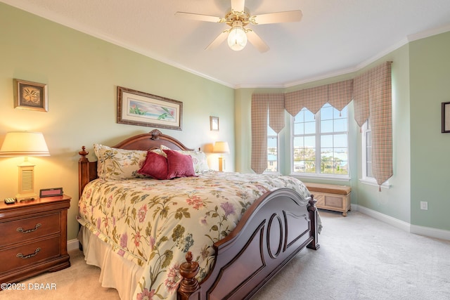 carpeted bedroom with ornamental molding and ceiling fan