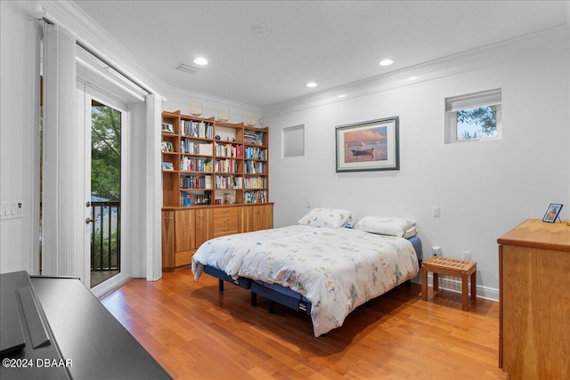 bedroom featuring light hardwood / wood-style floors, crown molding, and access to outside