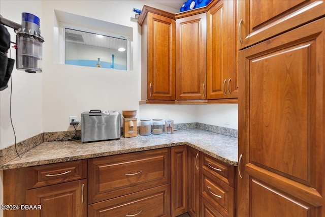 kitchen featuring light stone countertops