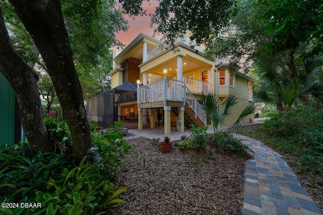 view of back house at dusk