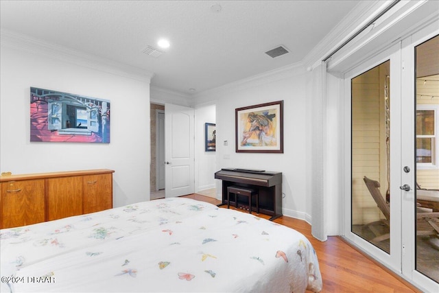 bedroom featuring ornamental molding and light hardwood / wood-style flooring