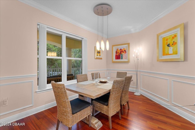 dining room with ornamental molding and dark hardwood / wood-style flooring