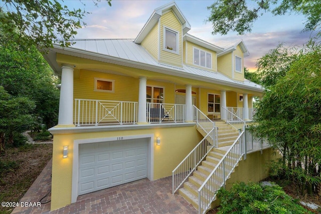 view of front of home with a garage and a porch