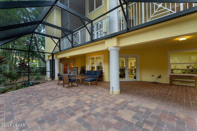 view of patio / terrace featuring glass enclosure, outdoor lounge area, and french doors