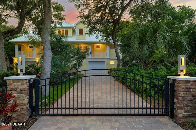 gate at dusk with a garage