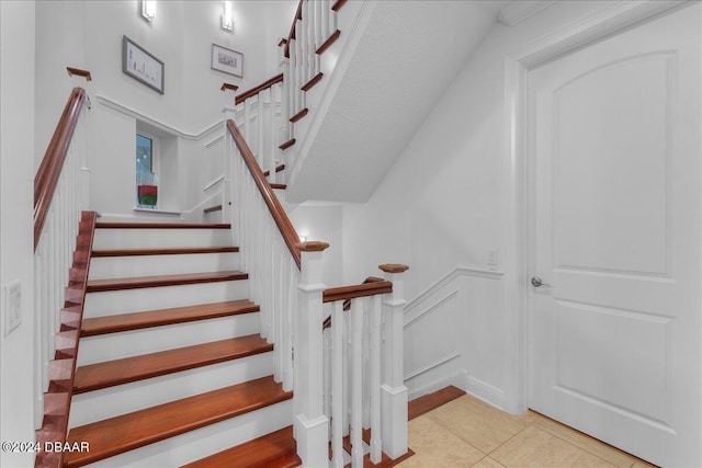 staircase with tile patterned floors