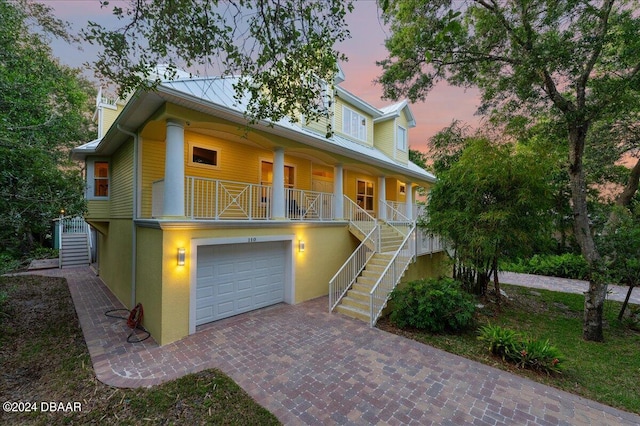 view of front of home featuring a garage and a porch