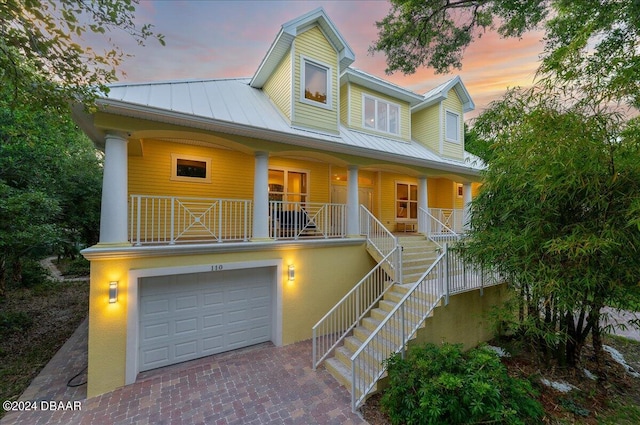 view of front of property featuring a garage and covered porch