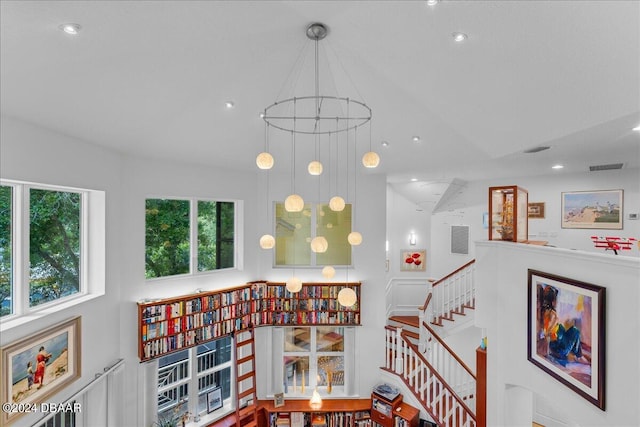 stairway with a chandelier