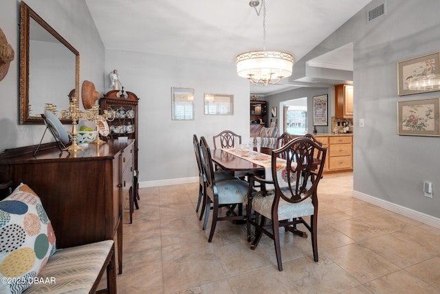 dining space with a notable chandelier and ornamental molding