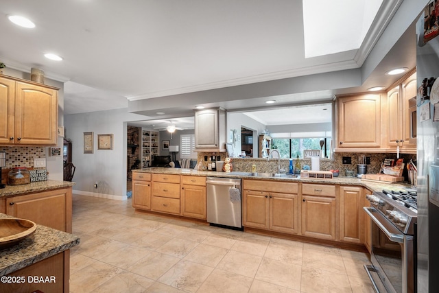 kitchen featuring light stone countertops, appliances with stainless steel finishes, sink, and ornamental molding