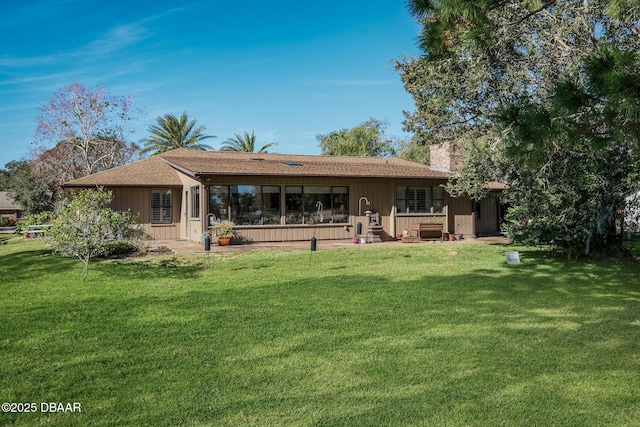 rear view of house with a lawn