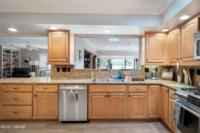 kitchen featuring ornamental molding, appliances with stainless steel finishes, sink, and a healthy amount of sunlight