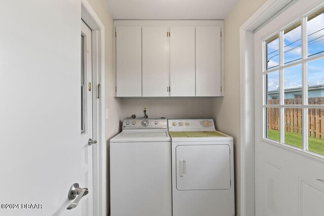 washroom featuring cabinets and independent washer and dryer