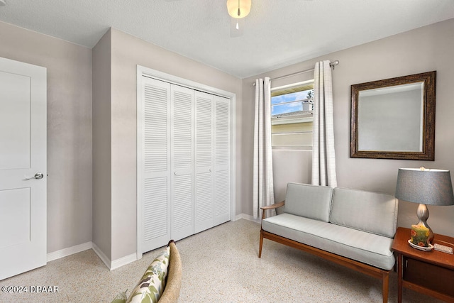 sitting room with a textured ceiling