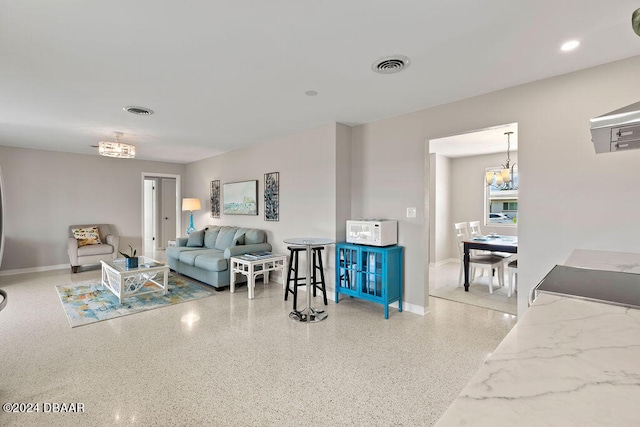 living room with a notable chandelier