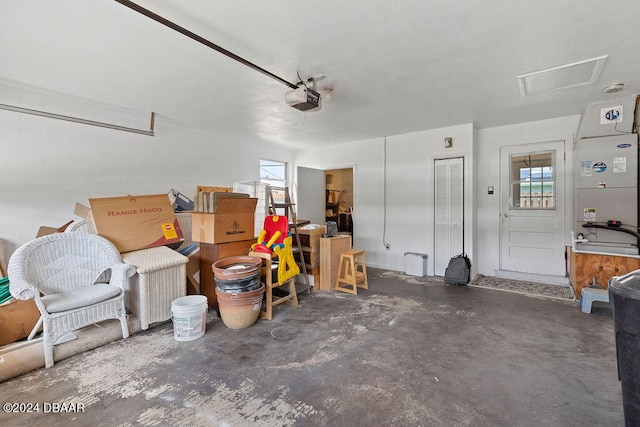 garage featuring heating unit and a garage door opener