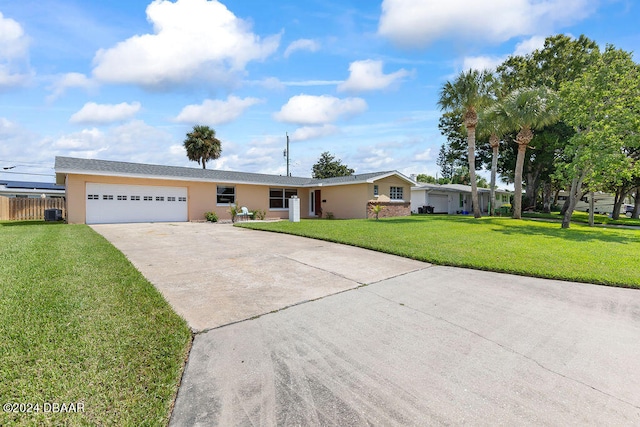 ranch-style house featuring a garage and a front lawn