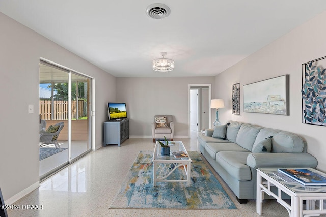 living room featuring a notable chandelier