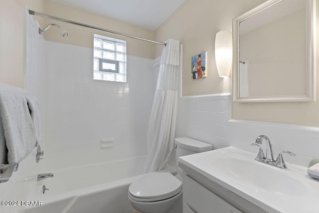 full bathroom with toilet, vanity, tile walls, and shower / bathtub combination with curtain