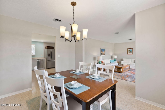 dining space featuring a notable chandelier