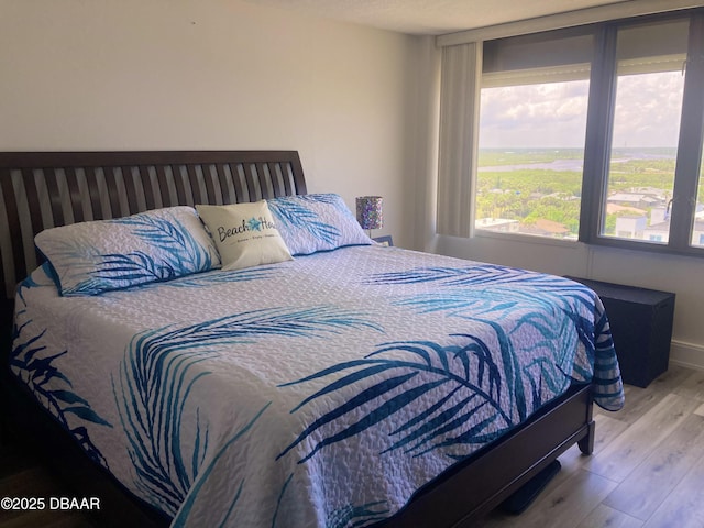 3580 S Ocean Shore Blvd Unit 905, Flagler Beach, FL 32136 - bedroom featuring multiple windows and wood finished floors