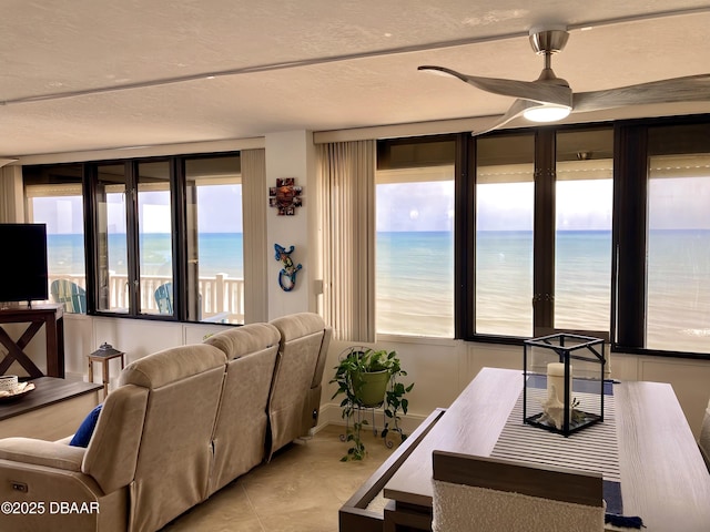3580 S Ocean Shore Blvd Unit 905, Flagler Beach, FL 32136 - living room featuring a water view, a ceiling fan, and a textured ceiling