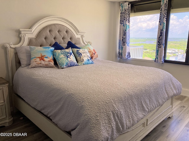 3580 S Ocean Shore Blvd Unit 905, Flagler Beach, FL 32136 - bedroom with dark wood finished floors and baseboards
