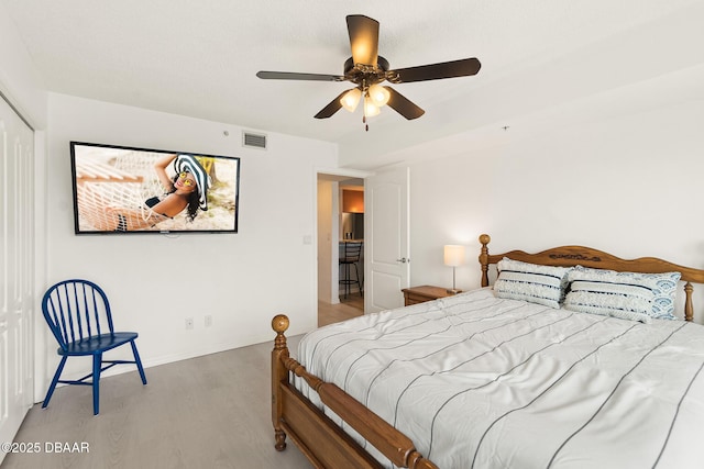 2937 S Atlantic Ave Unit 209, Daytona Beach Shores, FL 32118 - bedroom featuring light wood-style flooring, baseboards, and ceiling fan
