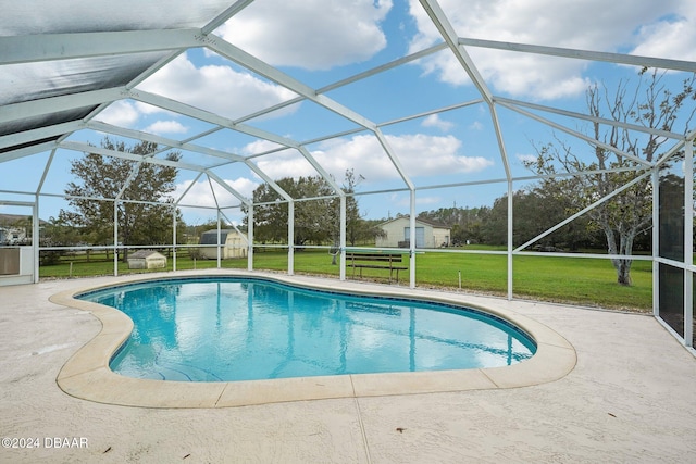 view of pool with a lanai, a yard, and a patio