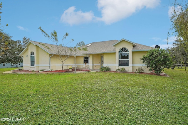 ranch-style house featuring a front lawn