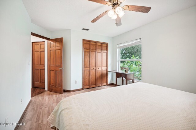 bedroom featuring a closet, light hardwood / wood-style flooring, and ceiling fan