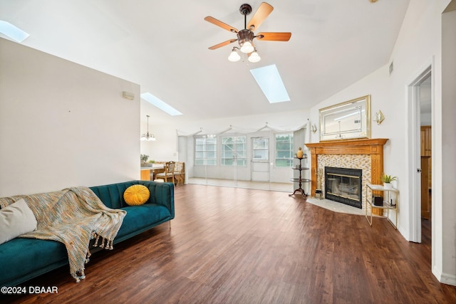 living room with a fireplace, hardwood / wood-style floors, vaulted ceiling, and ceiling fan