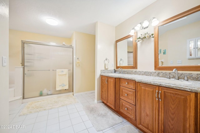 bathroom featuring tile patterned floors, vanity, and walk in shower