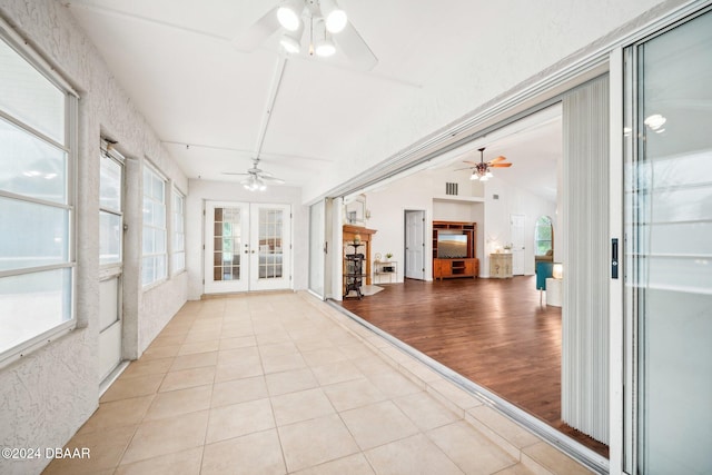 unfurnished sunroom featuring vaulted ceiling and french doors