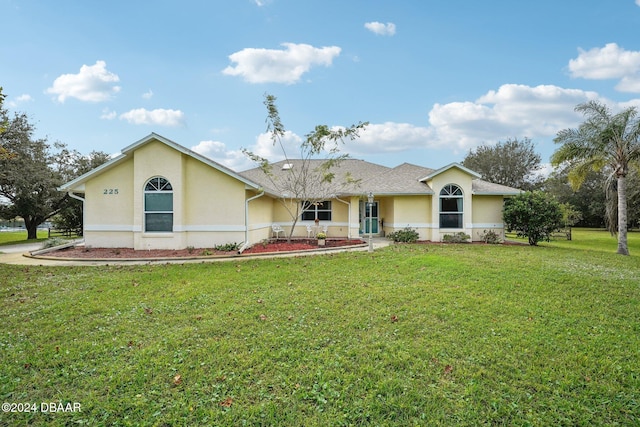 ranch-style home with a front yard