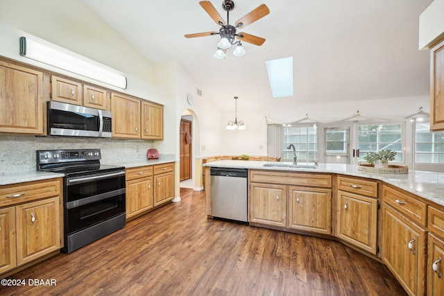 kitchen featuring decorative backsplash, stainless steel appliances, sink, decorative light fixtures, and dark hardwood / wood-style floors