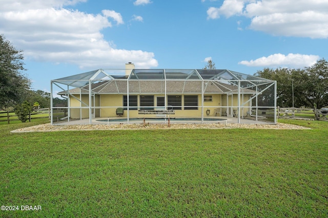 back of property with a lanai, a yard, and a patio