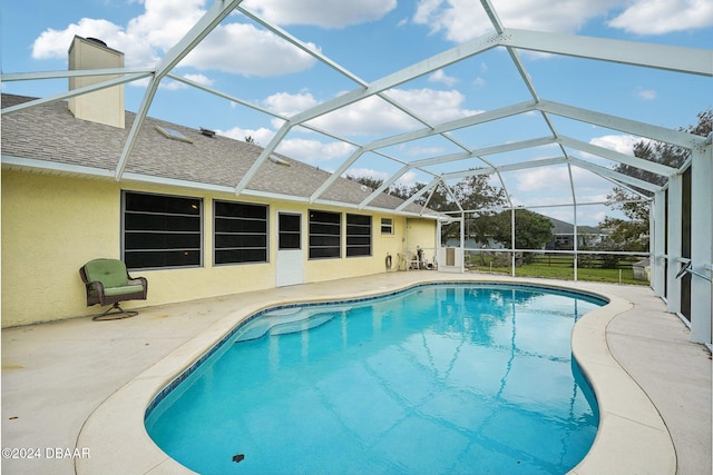 view of pool featuring a patio and glass enclosure