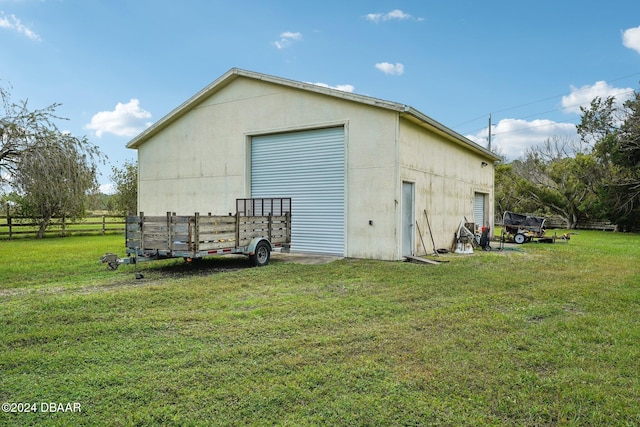 view of outbuilding featuring a lawn