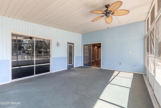 unfurnished sunroom featuring ceiling fan