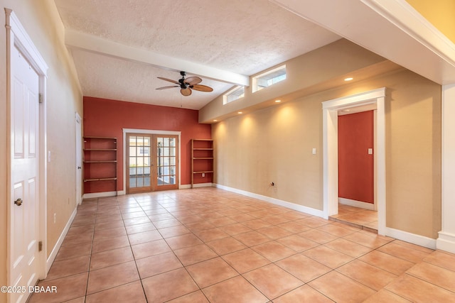 tiled spare room with a textured ceiling, ceiling fan, french doors, and lofted ceiling with beams