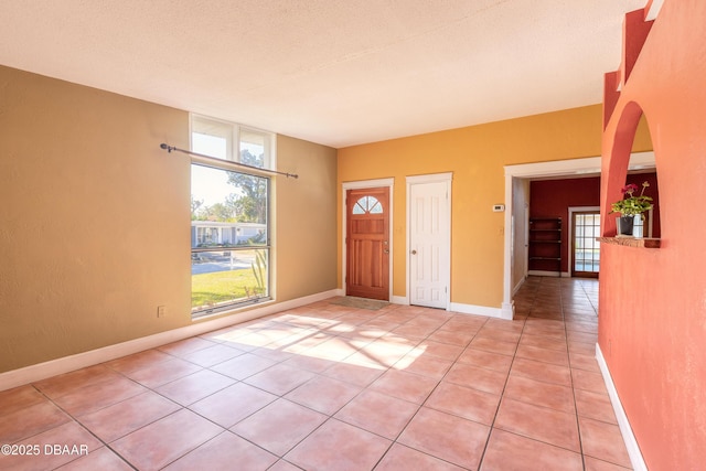 tiled foyer featuring a textured ceiling