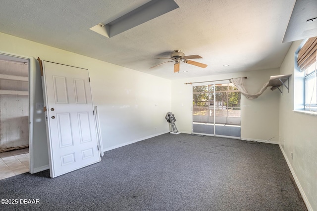 carpeted empty room featuring ceiling fan and a textured ceiling