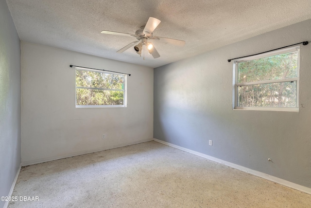 spare room with a textured ceiling and ceiling fan