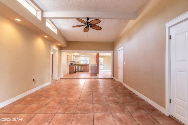 unfurnished living room featuring light tile patterned floors, ceiling fan, high vaulted ceiling, a textured ceiling, and beam ceiling