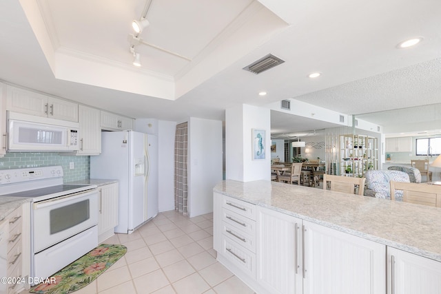 3855 S Atlantic Ave Unit 1206B, Daytona Beach Shores, FL 32118 - kitchen with white appliances, open floor plan, white cabinets, a tray ceiling, and light tile patterned floors
