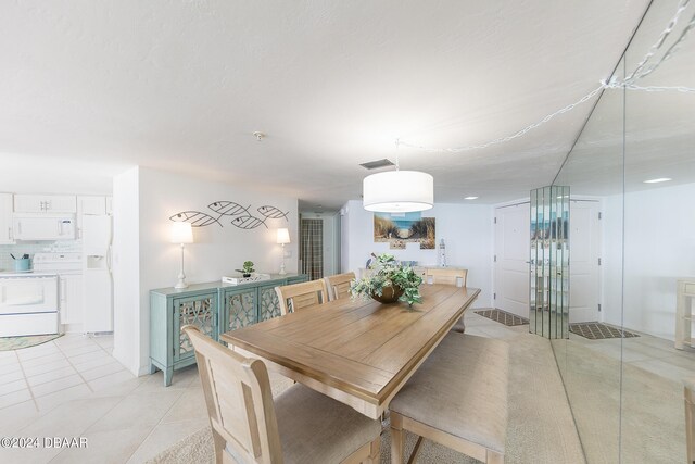 3855 S Atlantic Ave Unit 1206B, Daytona Beach Shores, FL 32118 - dining room featuring light tile patterned floors