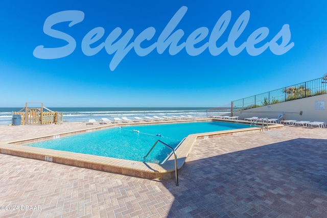 view of pool featuring a water view