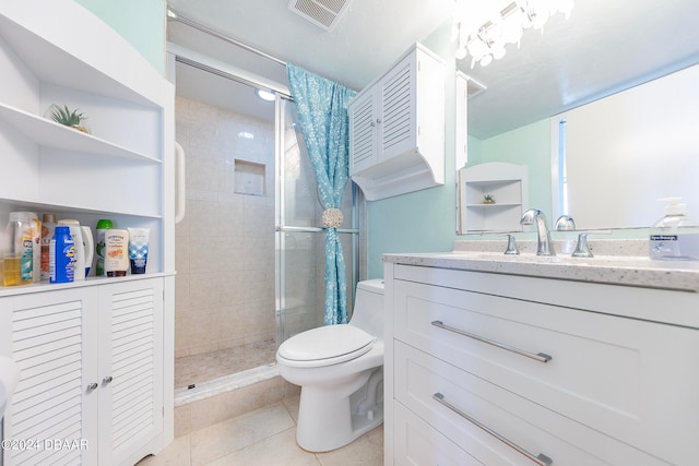 bathroom with vanity, walk in shower, tile patterned floors, and toilet